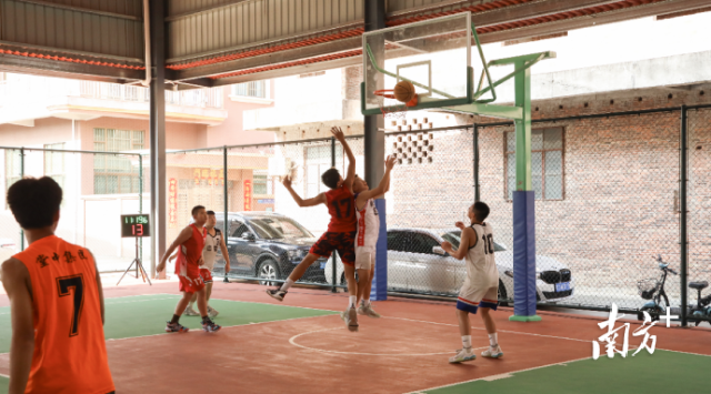 中堂镇风雨篮球场上，青少年正在切磋球技。